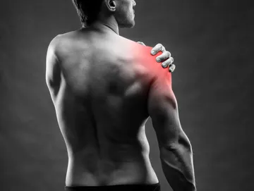 Man with shoulder pain, highlighted in red.