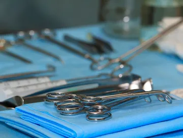 Surgical instruments on blue sterile cloth.