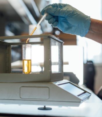 Scientist measuring liquid with a pipette in a laboratory.