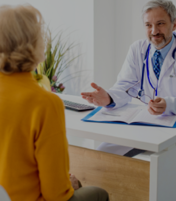 Doctor consulting elderly woman in clinic