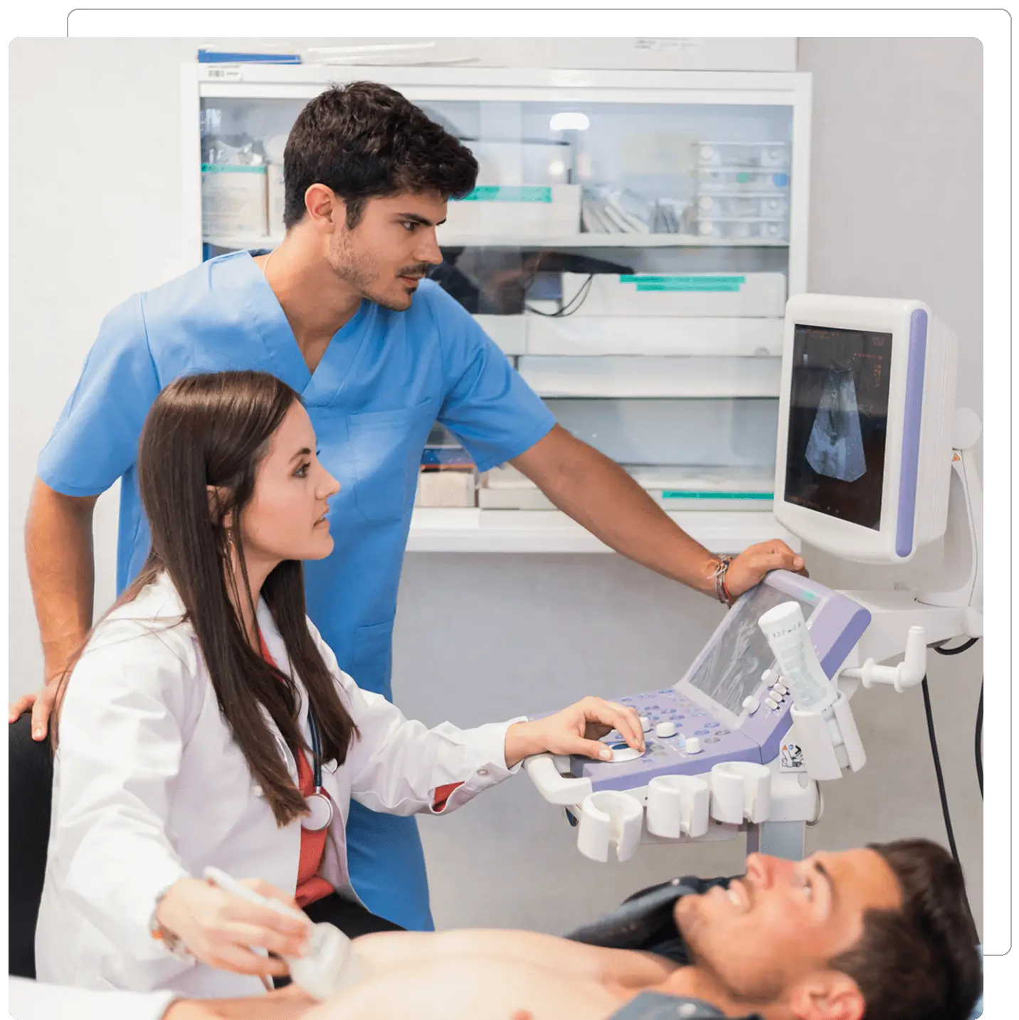 Doctor performing abdominal ultrasound on male patient